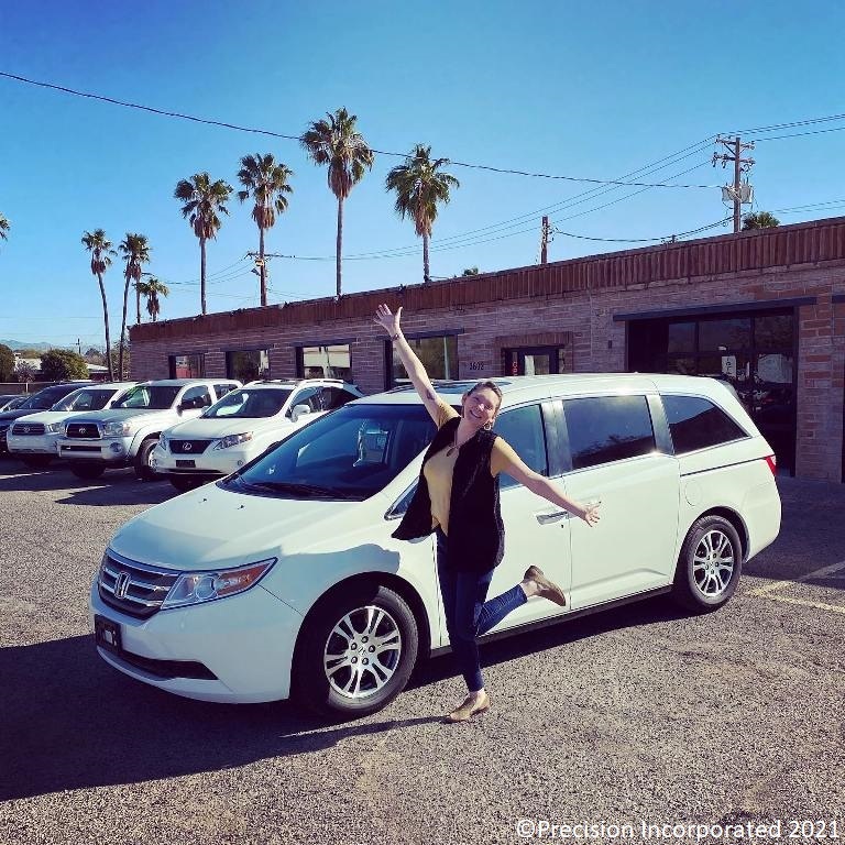 Happy woman with her new Honda Odyssey van