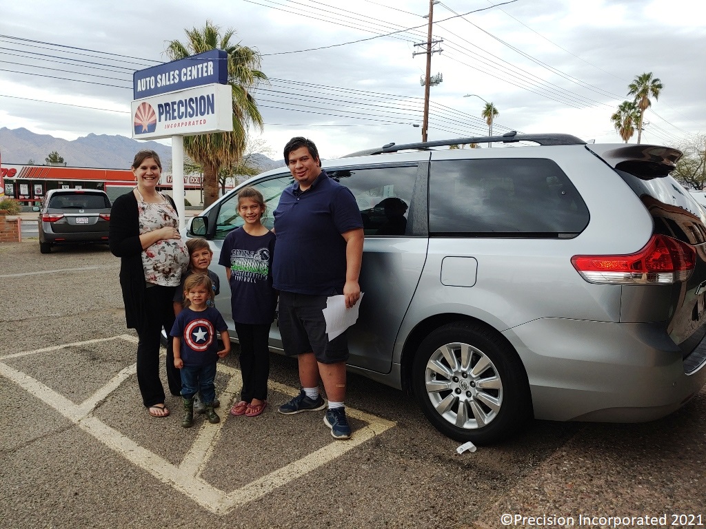 Happy family with their new Toyota Sienna