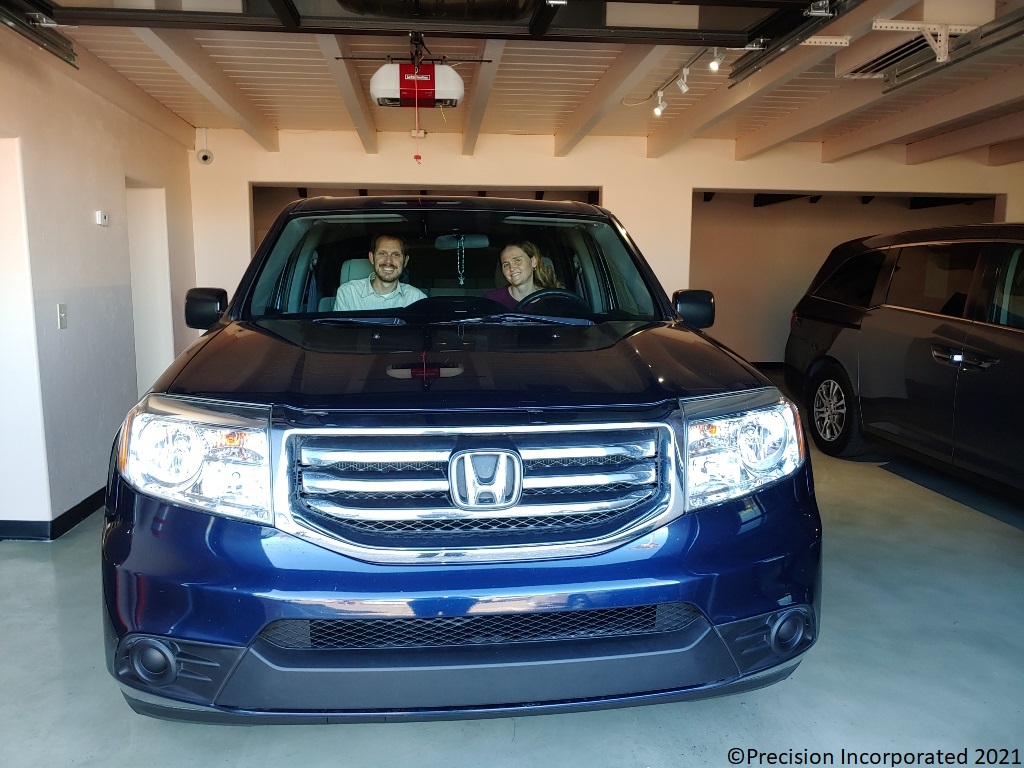 Husband & Wife smiling inside their new Honda Pilot